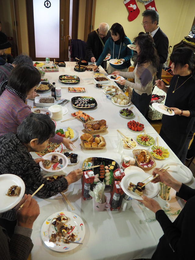 いまいさんの この一枚「クリスマス祝会からの１枚です。持ち寄りのおかずやお寿司などをみんなで楽しみました。<br>一般的にはランチパーティーと呼ぶのが適当でしょうが、改革派教会ではこのような食事会を「愛餐会」と呼ぶ習わしがあります。<br>」