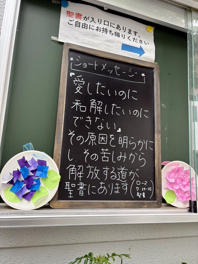 ぐちさんの この一枚「わたしはなんと惨めな人間なのでしょう。死に定められたこの体から、だれがわたしを救ってくれるでしょうか。 わたしたちの主イエス・キリストを通して神に感謝いたします。（ローマ7:24-25)<br><br>人間は、心の奥底にある自分でも赦せない深い闇を持っています。その闇に主イエスが光がさしてくださいます。それでも赦されていることを知らせてくださいます。その時、はじめて私たちは解放され顔を上げて、新しく歩き始めます。<br>今回の掲示は、日曜学校の子どもたちの作品と共にでした。」